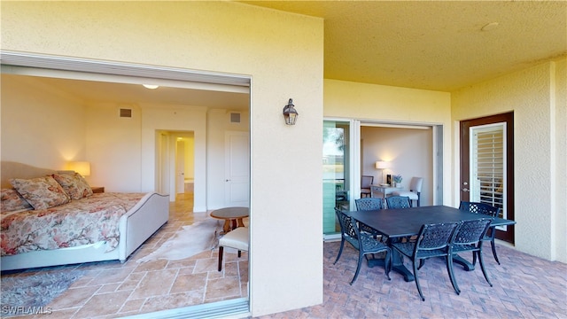 view of patio featuring outdoor dining area and visible vents