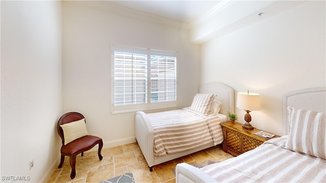 bedroom featuring baseboards and crown molding