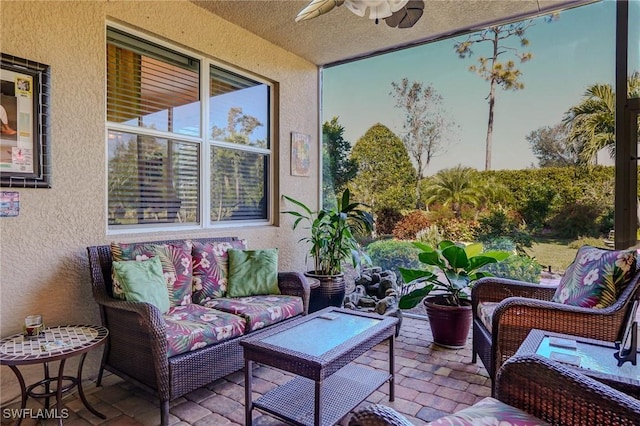 sunroom featuring ceiling fan