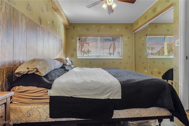 bedroom featuring multiple windows and ceiling fan