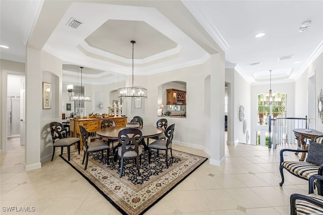 tiled dining space featuring crown molding, a chandelier, and a tray ceiling