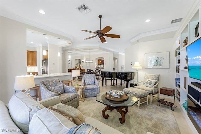 living room with crown molding and ceiling fan