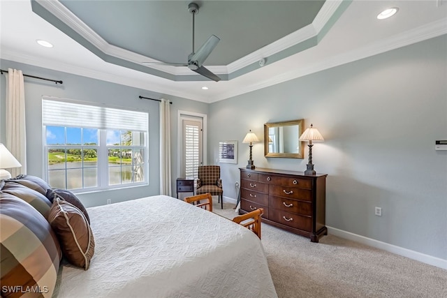 bedroom with crown molding, ceiling fan, a raised ceiling, and light colored carpet