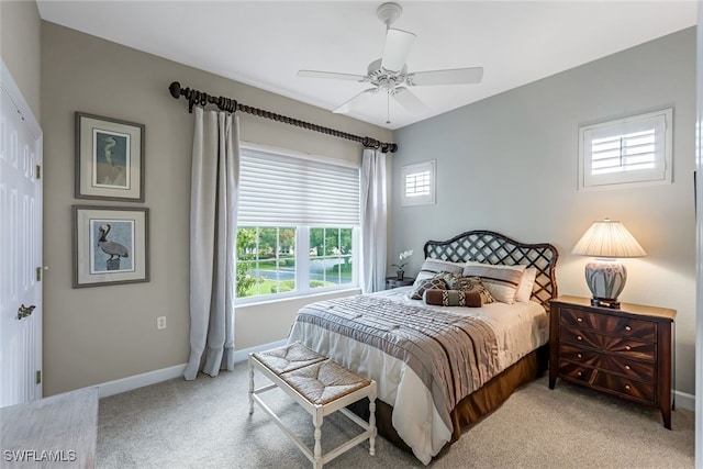 bedroom with ceiling fan, a closet, and light carpet