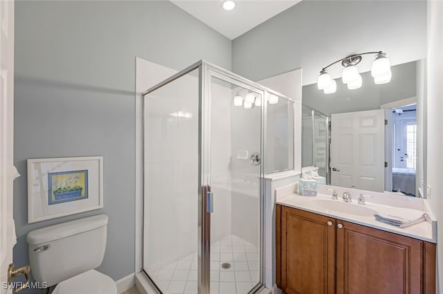 bathroom featuring vanity, an enclosed shower, and toilet