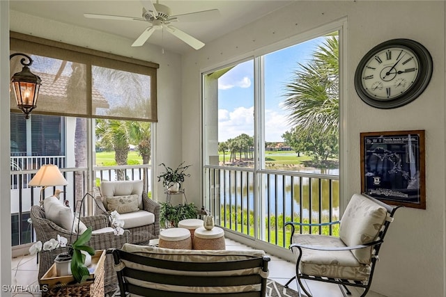 sunroom featuring a water view and ceiling fan