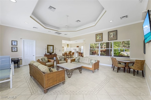 tiled living room featuring ceiling fan, ornamental molding, and a tray ceiling