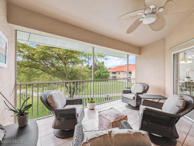 sunroom featuring ceiling fan