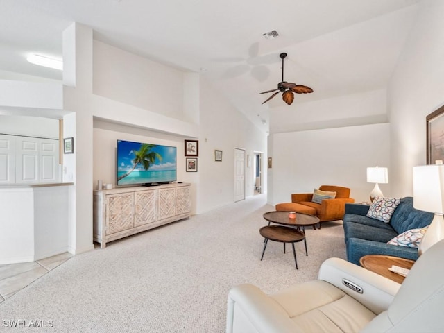 carpeted living room with high vaulted ceiling and ceiling fan