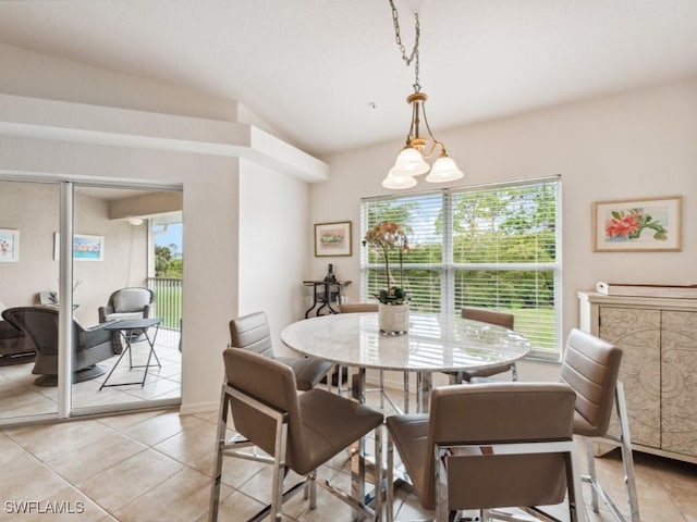 dining space with light tile patterned floors and a healthy amount of sunlight