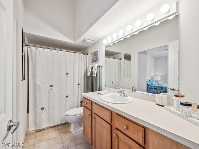 bathroom featuring tile patterned flooring, vanity, and toilet