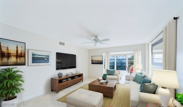 living room featuring ceiling fan and light tile patterned floors