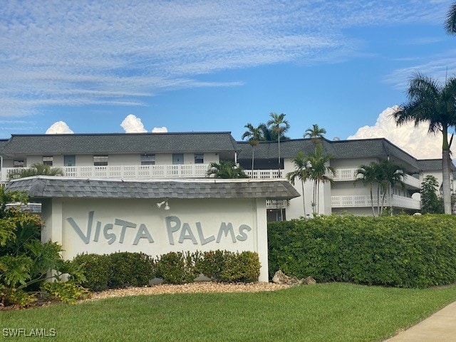 community sign featuring a lawn