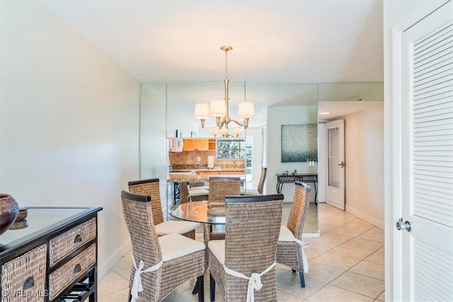 dining area featuring a notable chandelier and light tile patterned flooring