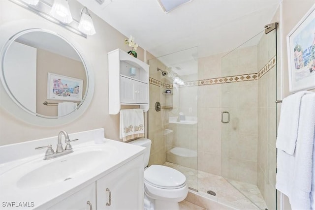 bathroom featuring vanity, an enclosed shower, and toilet