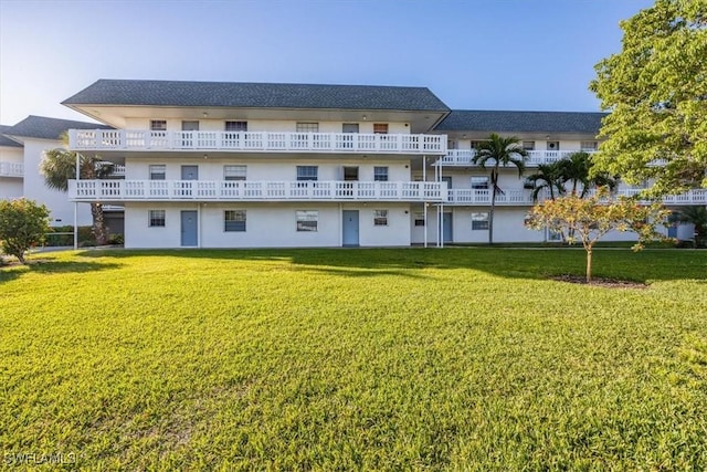 rear view of property with a lawn