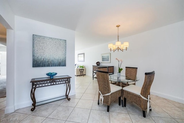 dining room featuring light tile patterned flooring and an inviting chandelier