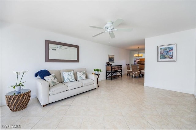 living room featuring ceiling fan with notable chandelier and light tile patterned flooring