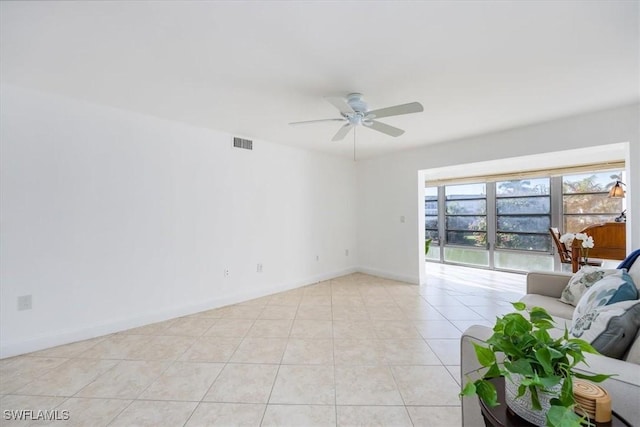 unfurnished living room with ceiling fan and light tile patterned floors