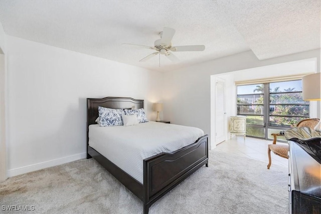 bedroom with ceiling fan, a textured ceiling, and light colored carpet