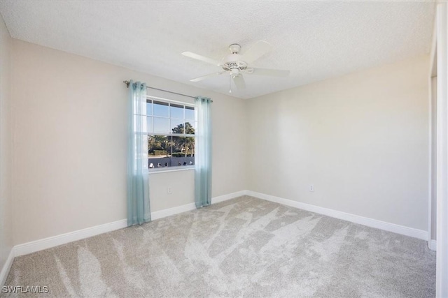 unfurnished room featuring a textured ceiling, carpet flooring, and ceiling fan