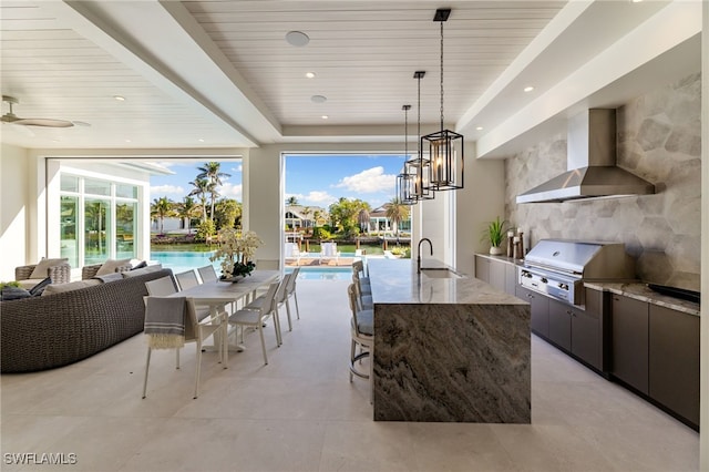view of patio featuring an outdoor kitchen, a grill, and a wet bar
