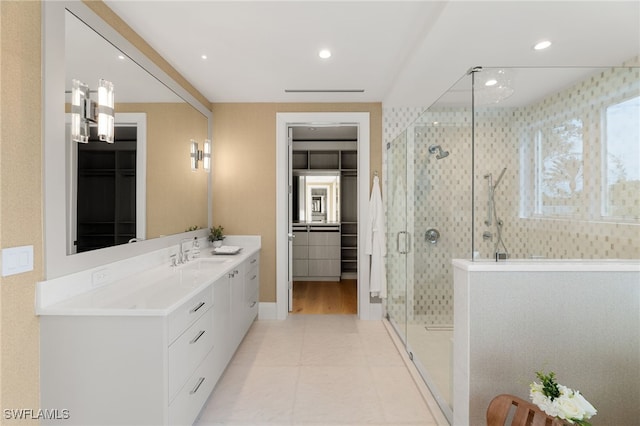 bathroom with vanity and a shower with shower door