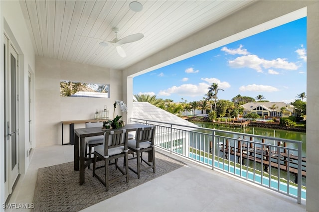 balcony featuring a water view and ceiling fan