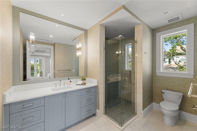 bathroom featuring walk in shower, vanity, and toilet