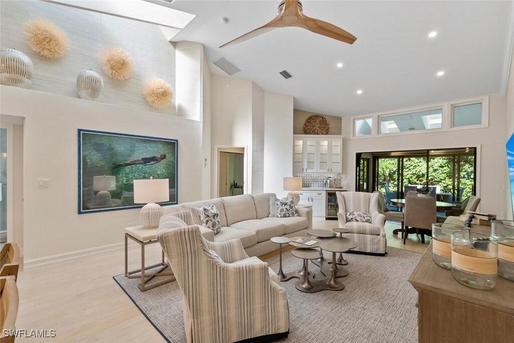 6656 Trident Way Unit J3, Naples, FL 34108 - living room featuring wine cooler, high vaulted ceiling, light wood-style floors, a ceiling fan, and recessed lighting