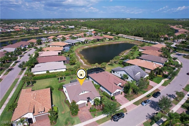 aerial view of property and surrounding area featuring nearby suburban area and a large body of water