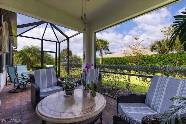 view of patio / terrace featuring outdoor dining area and glass enclosure