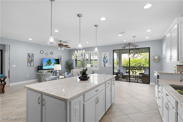 kitchen featuring a kitchen island, recessed lighting, plenty of natural light, hanging light fixtures, and a ceiling fan