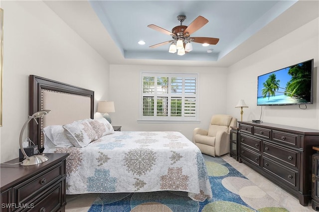 bedroom featuring a tray ceiling, ceiling fan, and recessed lighting