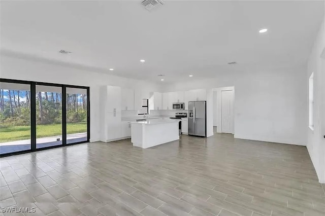 unfurnished living room with sink