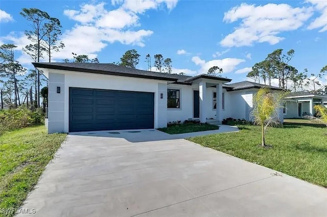 view of front of property featuring a garage and a front yard