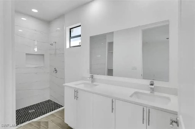 bathroom featuring vanity and tiled shower