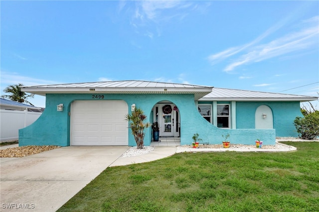 single story home with a garage and a front lawn