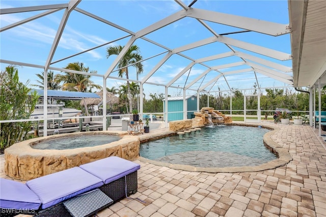 view of swimming pool featuring a patio, a storage unit, an in ground hot tub, pool water feature, and glass enclosure