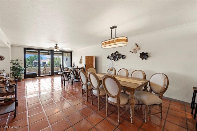 tiled dining area with crown molding, a textured ceiling, expansive windows, and ceiling fan