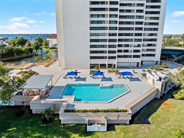 community pool featuring a patio area and a water view