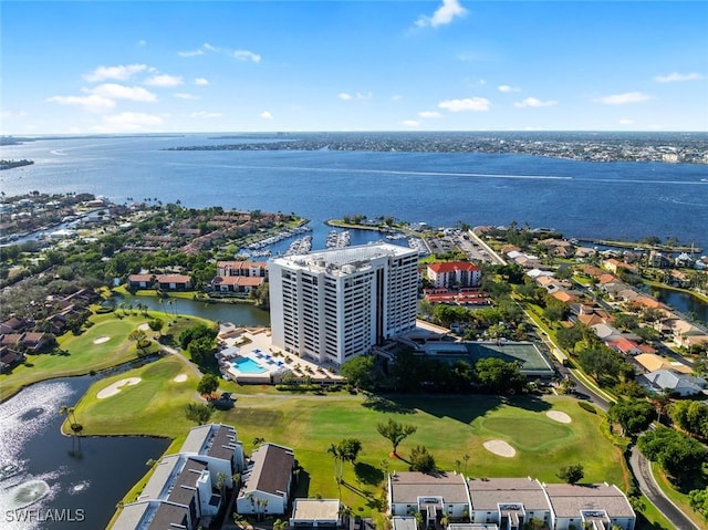 drone / aerial view with a water view and view of golf course