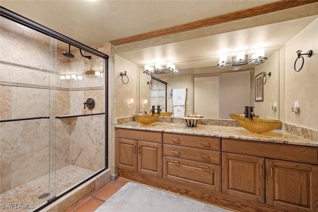 bathroom featuring an enclosed shower, vanity, and tile patterned flooring