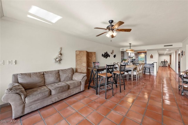 tiled living room featuring ceiling fan