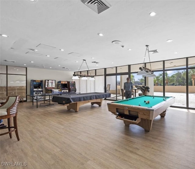 game room with a wall of windows, wood-type flooring, and billiards