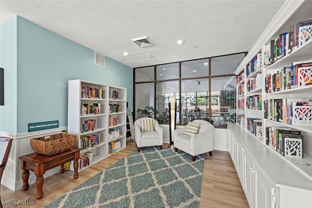 sitting room with visible vents and wood finished floors