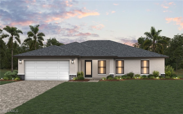 prairie-style home featuring a garage and a lawn