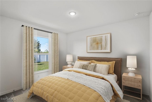 bedroom with multiple windows and carpet flooring