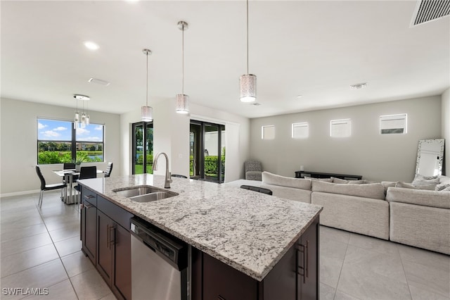 kitchen featuring dishwasher, dark brown cabinets, sink, and decorative light fixtures