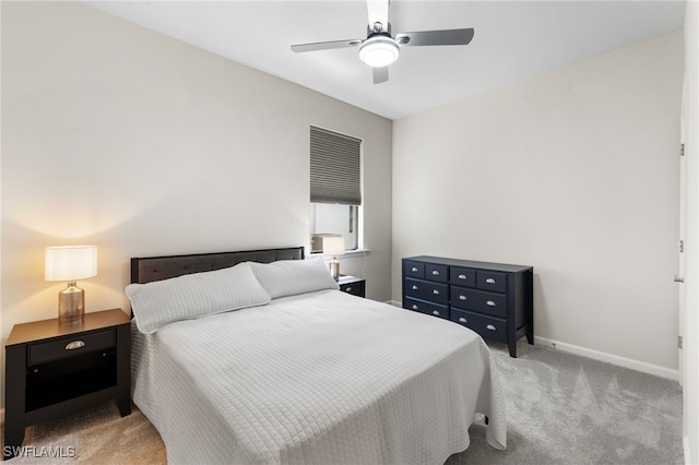 bedroom with light carpet and ceiling fan